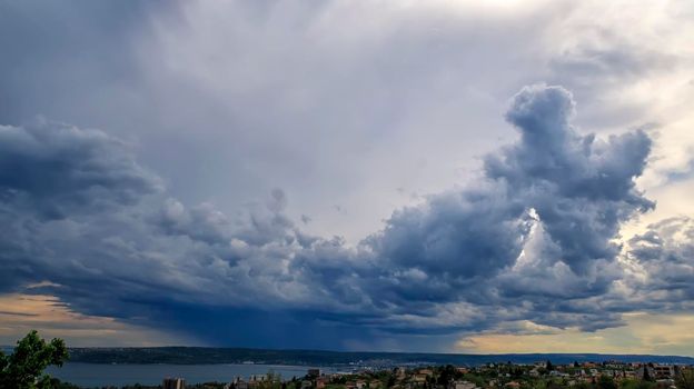 Amazing stormy clouds over the city. Horizontal view