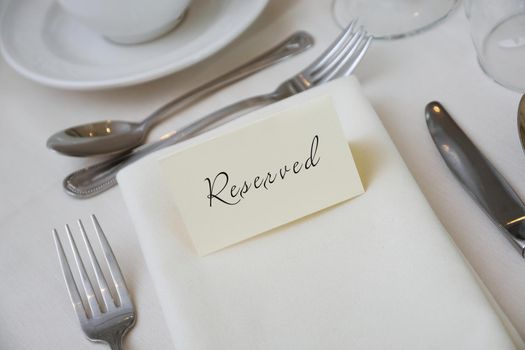 Reserved Sign at a Table Setting with White Tablecloth. High quality photo