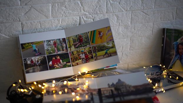 travel photo books lie near the Christmas tree. High quality photo