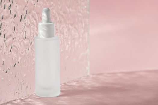 Hyaluronic acid oil, serum with collagen and peptides skin care product on background with acrylic ribbed plate. Cosmetic liquid mockup in transparent bottle. Mock up packaging, cosmetics design .