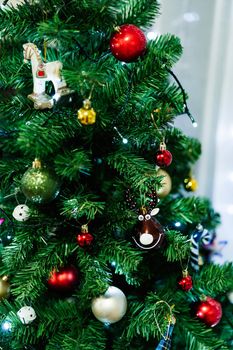 A toy ball on a Christmas tree in the shape of a deer head. High quality photo