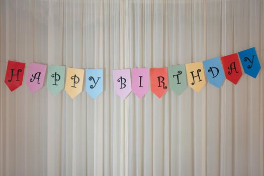 Celebrating Birthday, surprise with Happy birthday banner on wall.