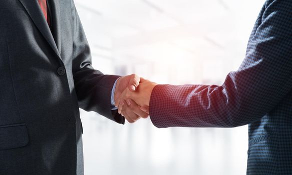 A close-up of a handshake. Making a deal between two businessmen