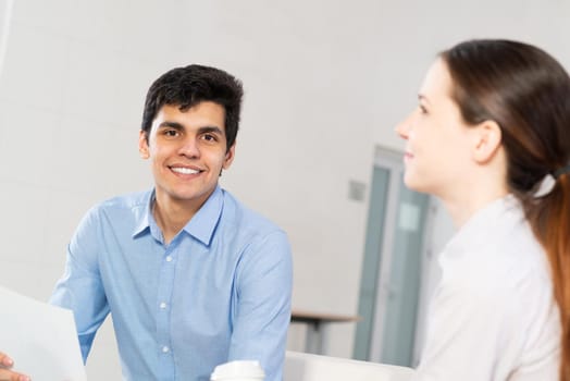 portrait of a young man at a business meeting. concept of team work