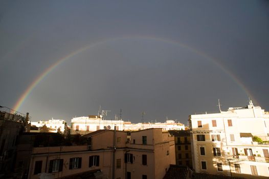 a rainbow overlooking Rome during a rainy day