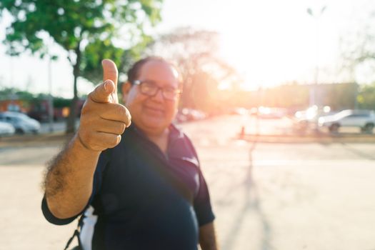 Local tourist mature latin man pointing his finger at camera during sunset in an outdoor park in Nicaragua during sunset