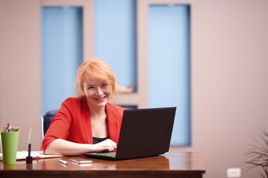 Businesswoman working on laptop at the office