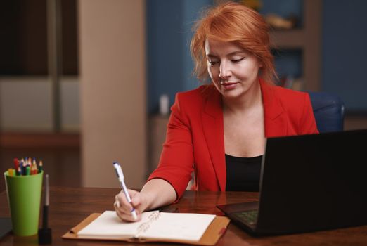 Businesswoman working on laptop at the office