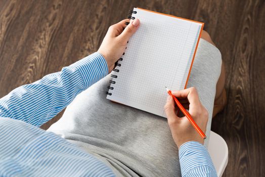 close-up a female hands with notebook and pencil