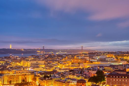 View over downtown Lisbon with the Christ Statue and the 25 de Abril bridge at night