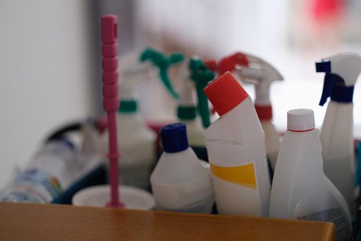 Lot of plastic bottles with detergents are on shelf in bathroom closeup. Cleaning of offices and apartments concept