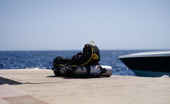 Diving equipment lying on wooden bridge in sea. Extreme sports concept