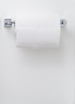 Modern paper towel holder on a white wall background