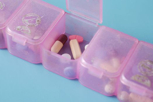 top view of medical pill box on color background
