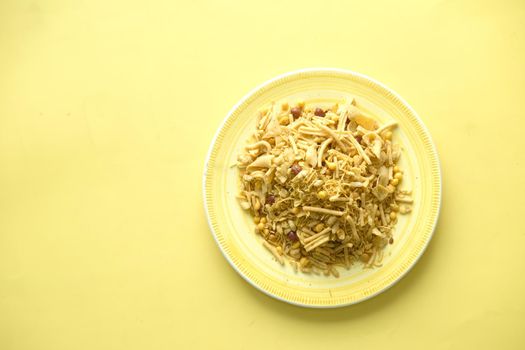 Bombay mix or Chiwda on yellow background .