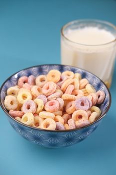 close up of colorful cereal corn flakes in a bowl .