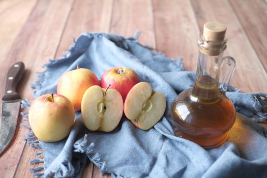 apple vinegar in glass bottle with fresh green apple on table ,
