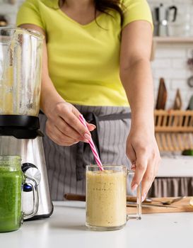 Healthy eating, dieting concept. Close up of a young woman holding a jar of fruit smoothie