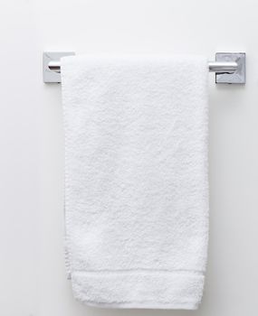 Modern bathroom towel dryer on a white wall background