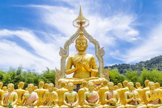 Row of disciple statues surrounding big buddha statue in public to the general public worship worship of Nakhon Nayok, Thailand.