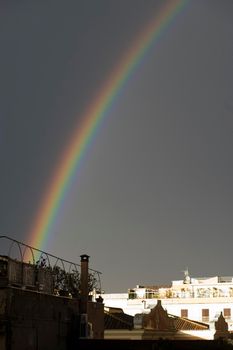 a rainbow overlooking Rome during a rainy day