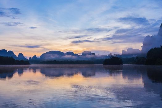 Ban Nong Thale the natural scenery of the sunshine in the morning (mountains, lakes, trees, fog) at Krabi, Thailand.