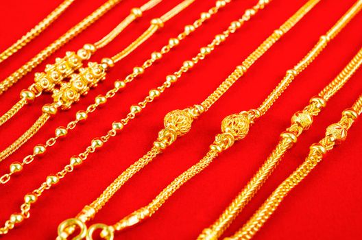 The set of gold necklace on red Velvet fabric.