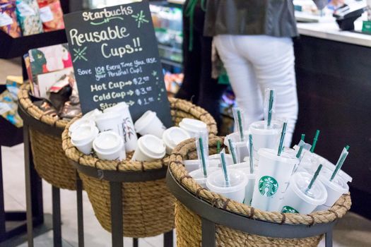 NEW YORK, USA - 17 MAY, 2019: Starbucks reusable coffee cups on sale in cafe in New York. People who use their own cup get discount for coffee