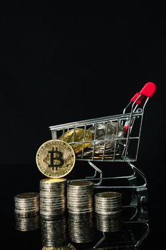 Close up Bitcoin coin in shopping cart on black background