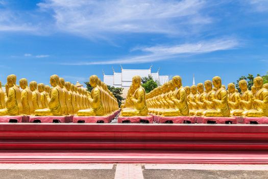 Row of disciple statues surrounding big buddha statue in public to the general public worship worship of Nakhon Nayok, Thailand.