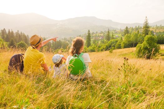 Free family looking at landscape travel Ukraine. Hiking family vacation holiday summer travel local trekking mountain. Pointing family mountain vacation time together travel child and parents and kids