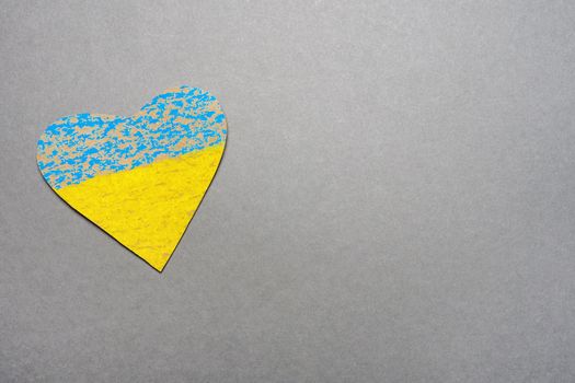 No war kids making symbol heart Ukraine flag painted yellow blue. National symbol ukraine painted child drawing heart isolated on gray background. Save Ukraine sign support concept heart shape love UA