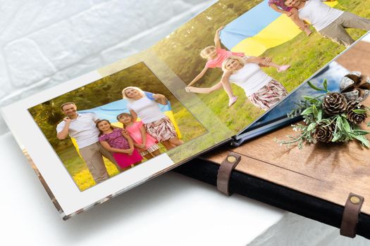 Family photos archive saved in brightly designed photo book; bright summer memories placed in the photobook. family with flag of ukraine.