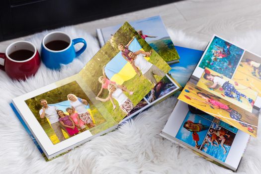 Family photos archive saved in brightly designed photo book; bright summer memories placed in the photobook. family with flag of ukraine.