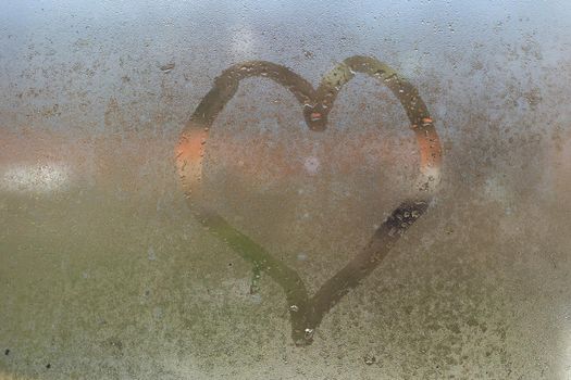 Painted heart on the foggy window. I love you on Valentine's Day