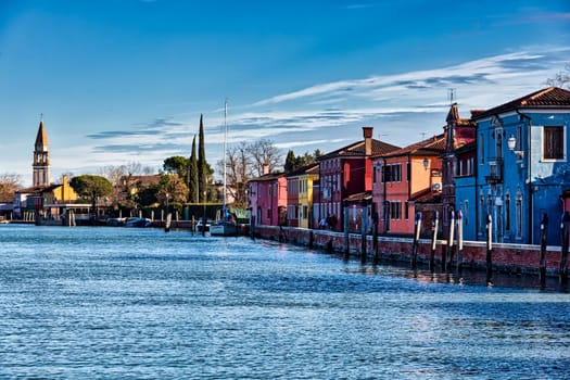 View of the San Michele Arcangelo bell tower and the colorful houses of Mazzorbo, Venice