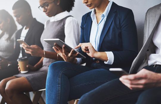 Cropped shot of a group of young businesspeople waiting in line for their interviews.