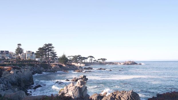 Rocky craggy ocean beach, big sea waves crashing on shore, Monterey 17-mile drive, California coast, USA. Water splashing in Pacific Grove, beachfront waterfront promenade, waterside park seascape.