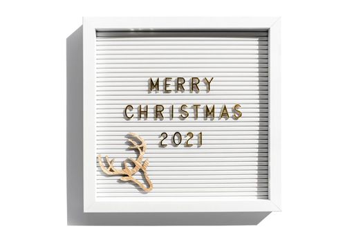 Letter board with Merry Christmas 2021 greeting, greeting quote on letterboard on white backdrop. Flat lay, from above, minimal style