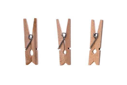 Set of decorative wood beige clothespins isolated on white background. Cloth hanger. Macro, closeup