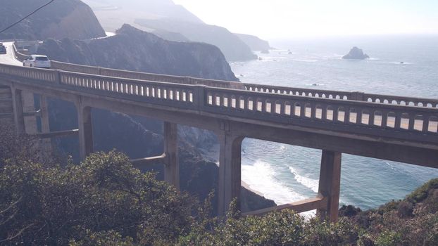 Bixby creek bridge, arch architecture. Pacific coast highway 1 landmark. Historic scenic Cabrillo road. Coastal road trip, journey or travel by ocean. Canyon in foggy weather. California, Big Sur, USA