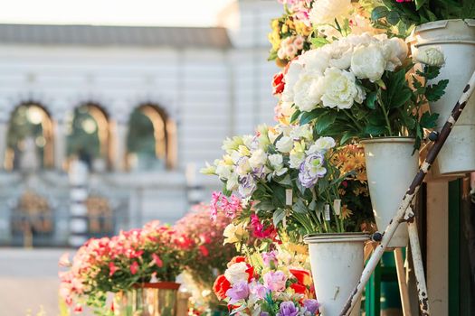 Outdoor flower market with roses, peonies and lilies. Fresh flowers street shop in historic downtown. Milan, Italy