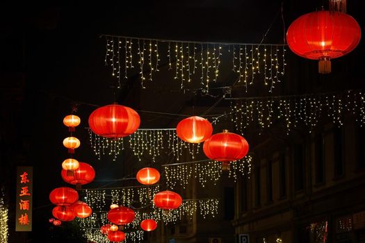 Chinese new year red lanterns in Chinatown. Decorations on the street in night time