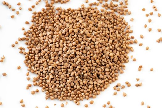 Buckwheat grains. Pile of buckwheat isolated on white background. Top view. The concept of diet and healthy eating, the background texture of the buckwheat. Buckwheat. Grain culture