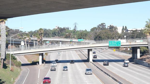 Multiple lane highway interchange or intersection, freeway overpass bridge. Cars traffic on road, California transportation infrastructure, San Diego, USA. Crossroad junction in city near Los Angeles.