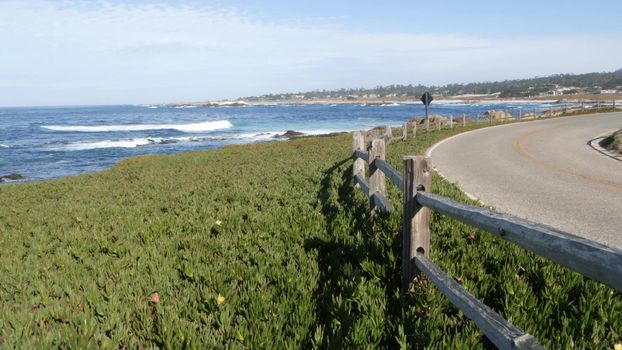 17-mile drive scenic road, Monterey, California USA. Trip along ocean, sea waves. Pacific coast highway tourist route near Point Lobos, Big Sur and Pebble beach. Fence and succulent ice plant greenery
