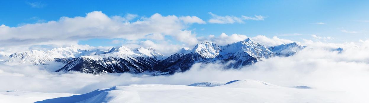 Panoramic view of mountains near Brianson, Serre Chevalier resort, France. Ski resort landscape on clear sunny day. Mountain ski resort. Snow slope. Snowy mountains. Winter vacation. Panorama