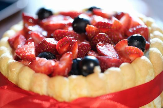 Closeup of delicious biscuit fresh strawberry cake. Home baking recipes concept