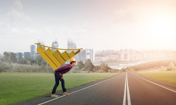 Young man builder carrying growing graph on his back