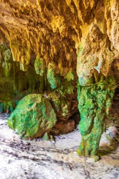 Amazing blue turquoise water and limestone cave sinkhole cenote at Santuario de los guerreros in Puerto Aventuras Quintana Roo Mexico.